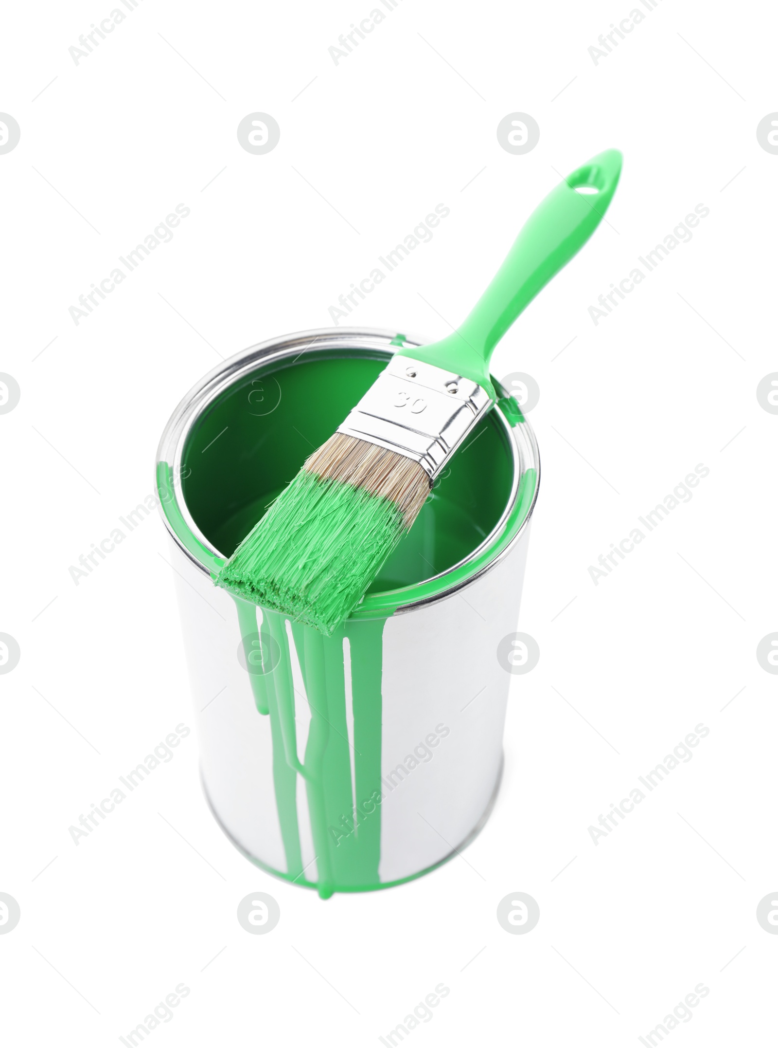 Photo of Can of light green paint and brush isolated on white