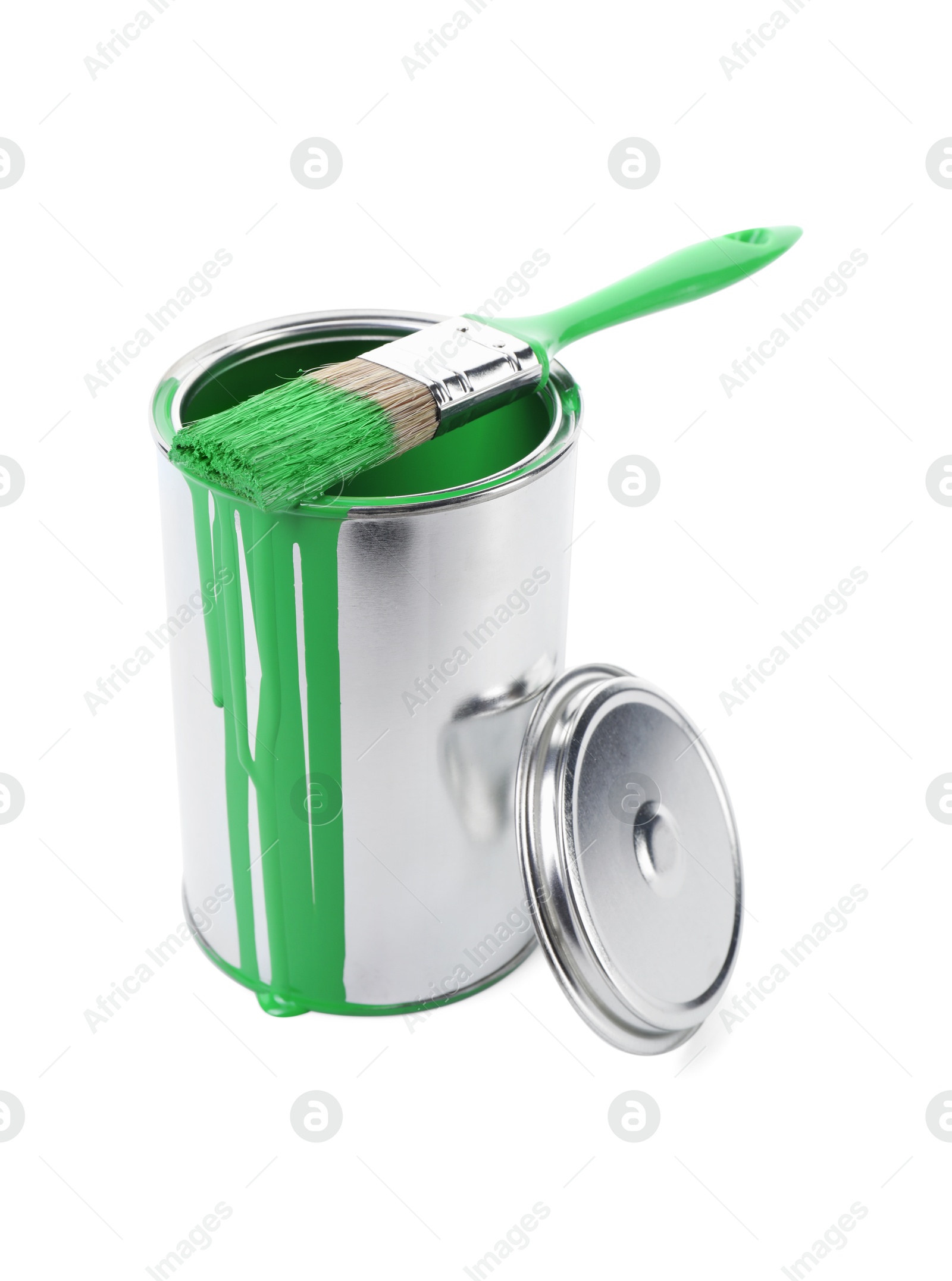 Photo of Can of light green paint and brush isolated on white