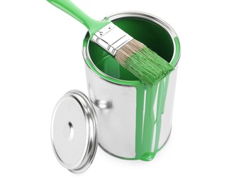 Photo of Can of light green paint and brush isolated on white