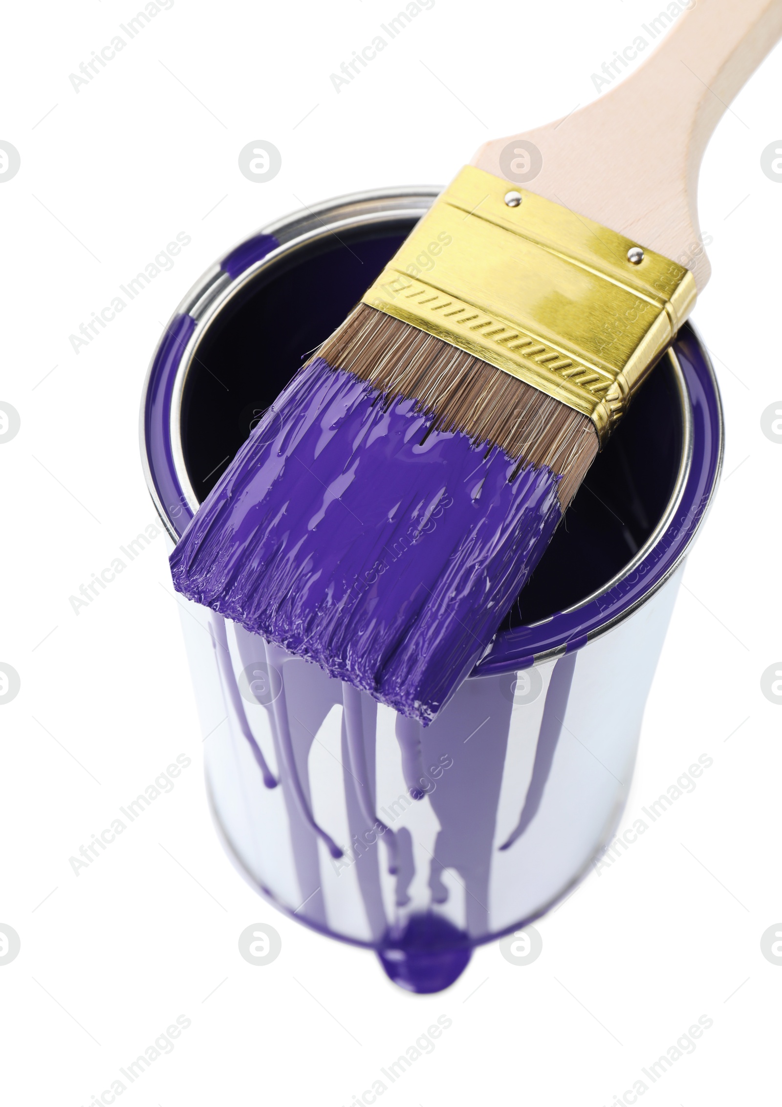 Photo of Can of violet paint and brush isolated on white