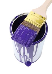 Photo of Can of violet paint and brush isolated on white