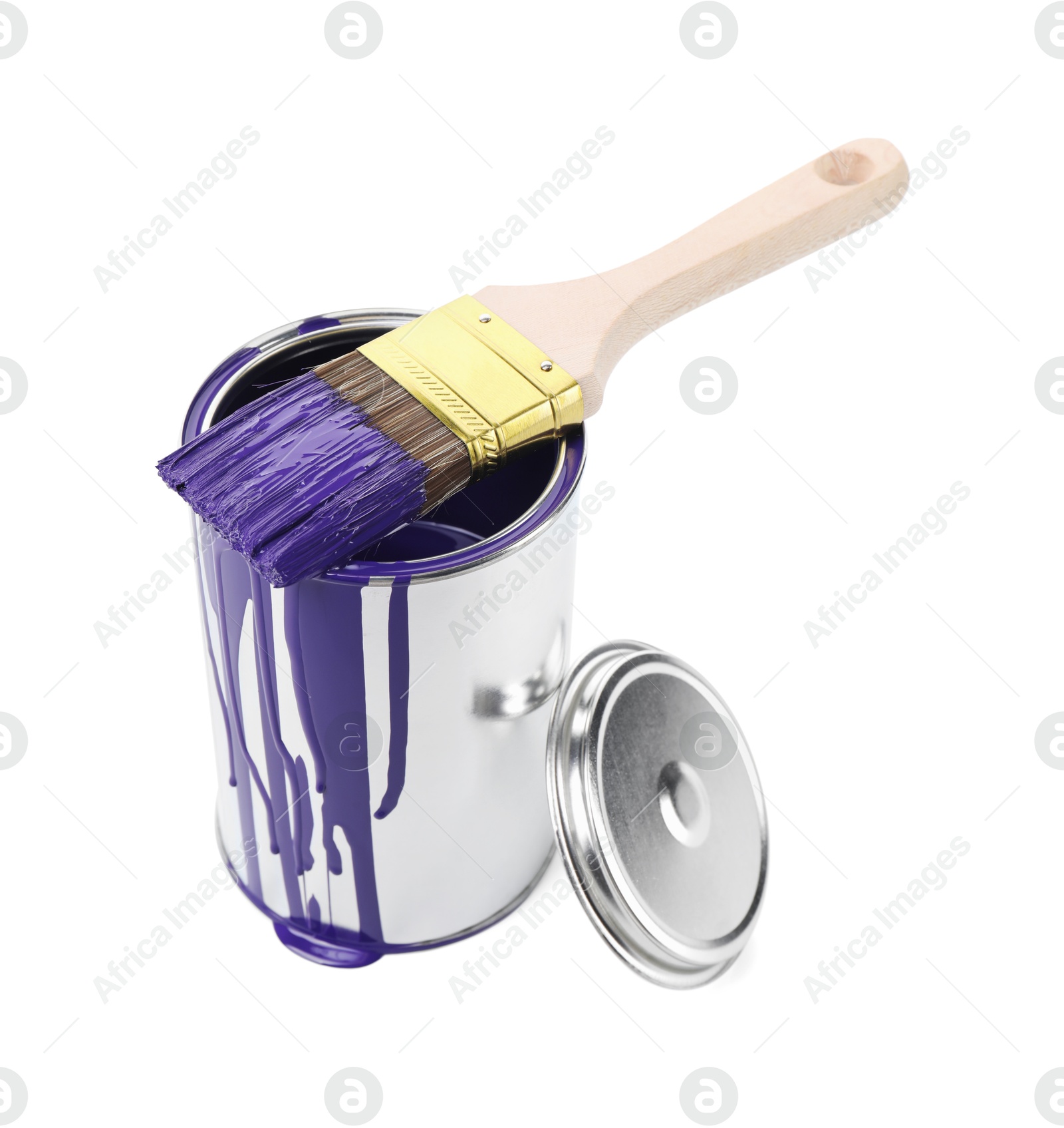 Photo of Can of violet paint and brush isolated on white