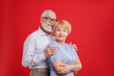 Photo of Portrait of lovely senior couple on red background