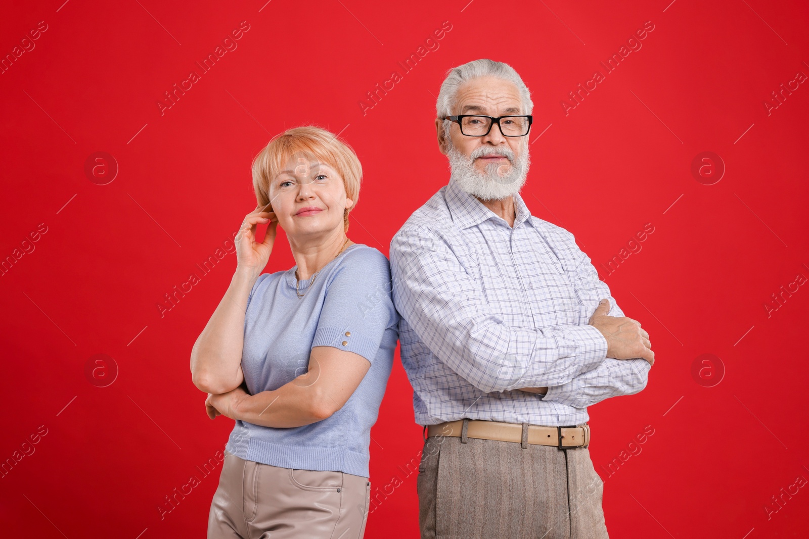 Photo of Portrait of lovely senior couple on red background