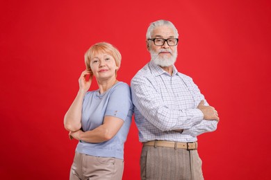 Photo of Portrait of lovely senior couple on red background