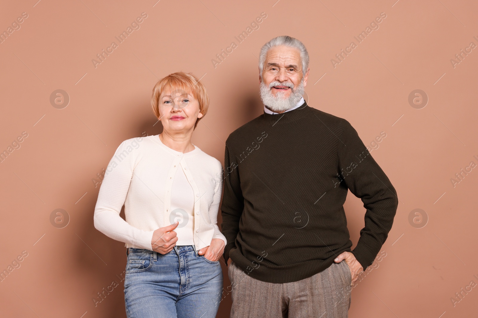 Photo of Portrait of lovely senior couple on beige background