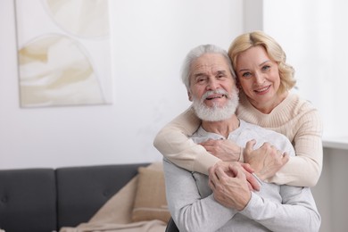 Photo of Senior man and mature woman at home, space for text. Happy couple