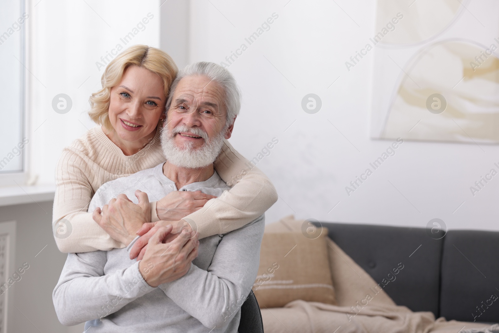 Photo of Senior man and mature woman at home, space for text. Happy couple