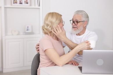 Senior man and mature woman spending time together at home. Happy couple