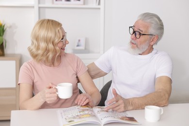 Senior man and mature woman spending time together at home. Happy couple