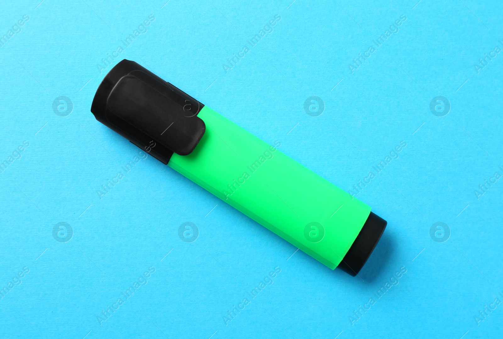 Photo of Bright highlighter on light blue background, top view