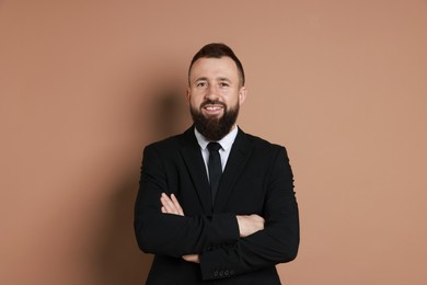 Handsome bearded man in suit on brown background