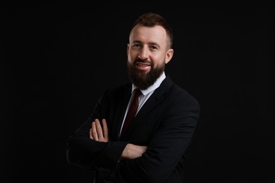 Photo of Handsome bearded man in suit on black background