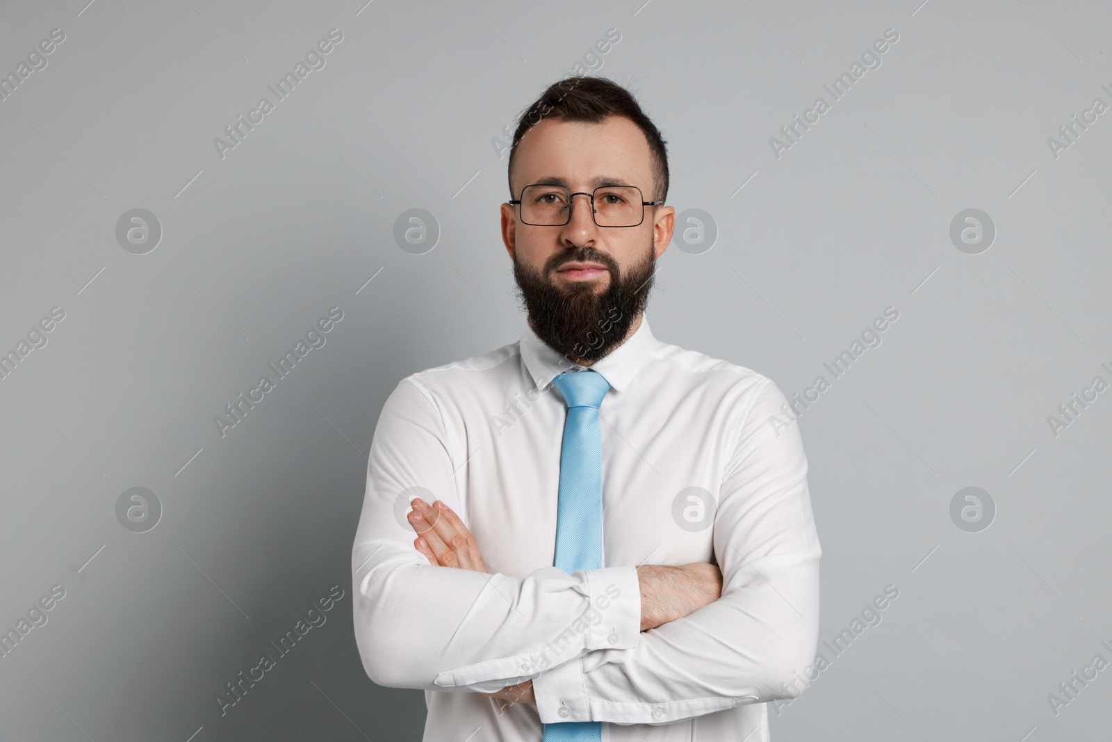 Photo of Handsome bearded man in formal outfit on grey background