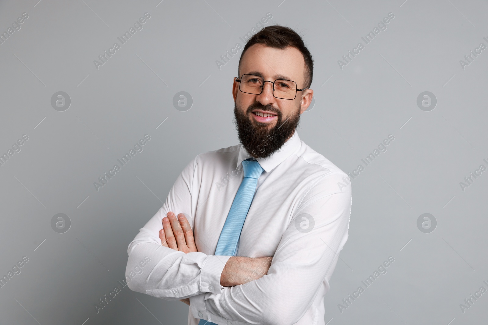 Photo of Handsome bearded man in formal outfit on grey background