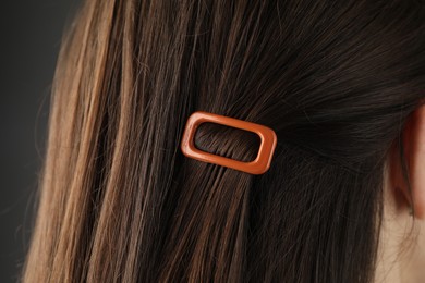 Photo of Woman with beautiful hair clip on grey background, closeup