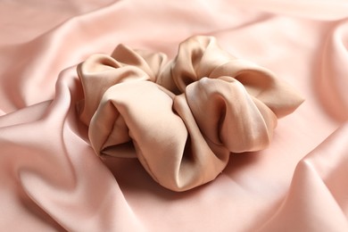 Hair scrunchie on pink silk fabric, closeup