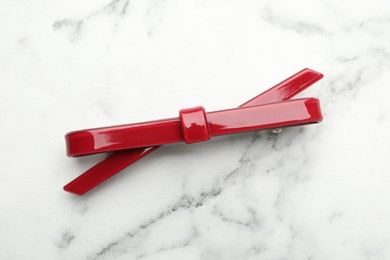 Photo of Beautiful hair clip on white marble table, top view