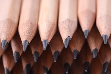 Photo of Many graphite pencils as background, closeup view