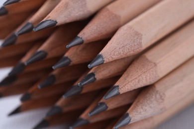 Photo of Many pencils on light grey background, closeup