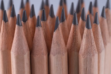 Photo of Many pencils on light grey background, closeup