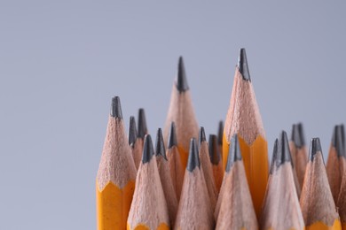 Many pencils on light grey background, closeup. Space for text