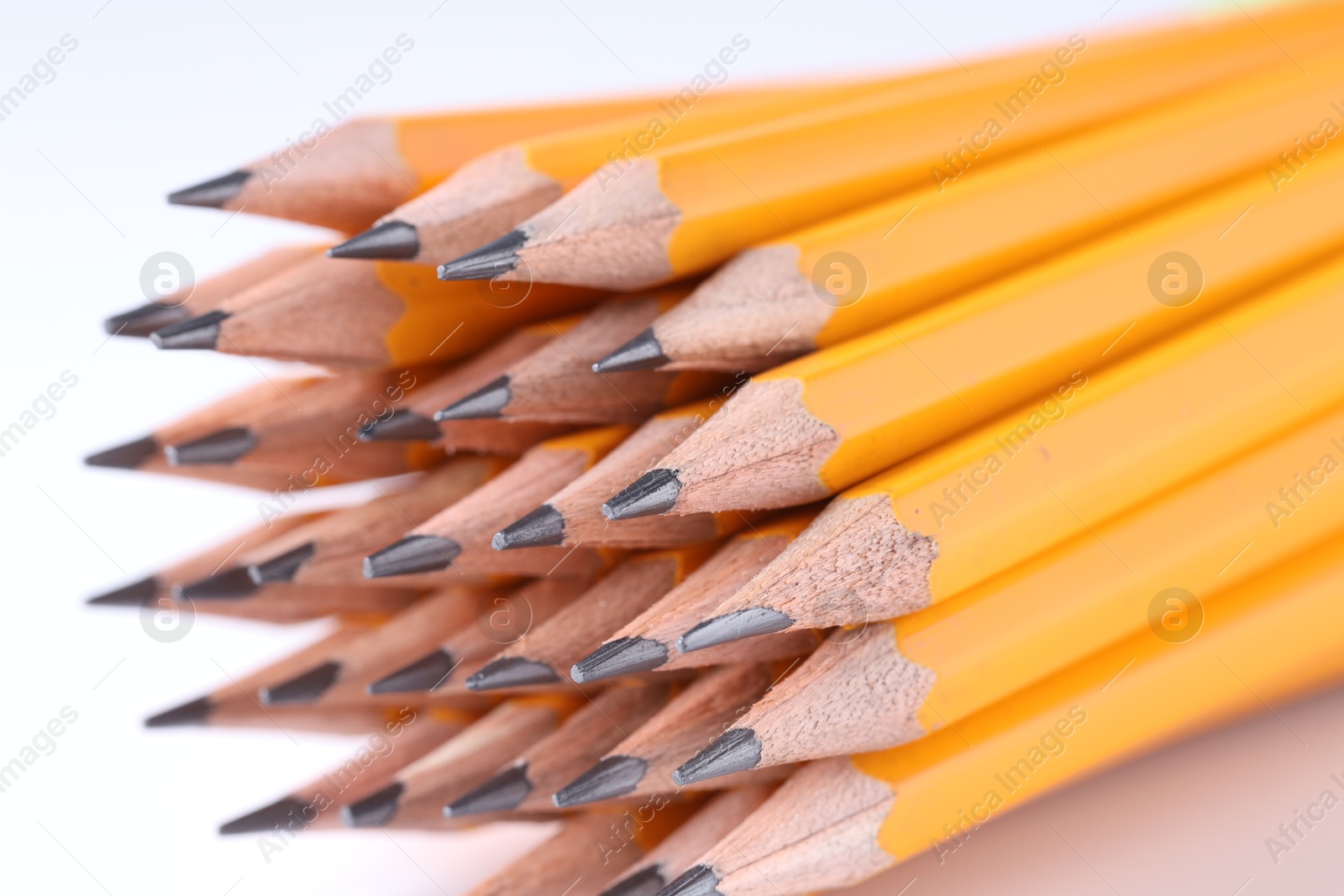 Photo of Many pencils on light grey background, closeup