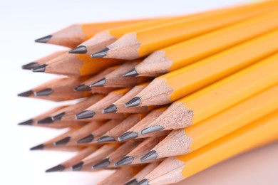 Photo of Many pencils on light grey background, closeup