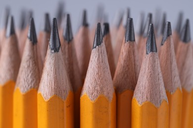 Photo of Many pencils on light grey background, closeup