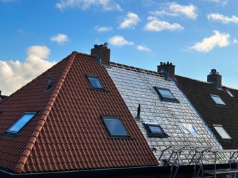 Photo of Residential building with roof renovation under blue sky