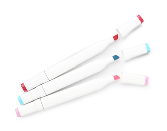 Photo of Double-sided marker pens on white background, top view