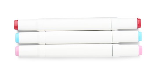 Photo of Double-sided marker pens on white background, top view