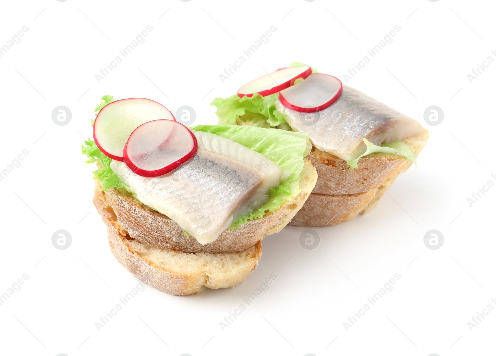 Photo of Tasty sandwiches with herring, radish and lettuce on white background