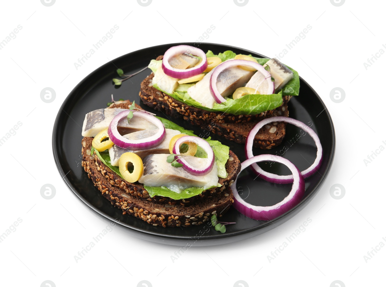 Photo of Tasty sandwiches with herring, onions, lettuce and olives isolated on white