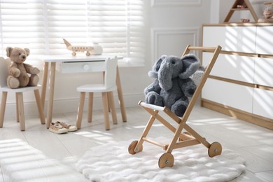 Different toys and stylish furniture in child's room