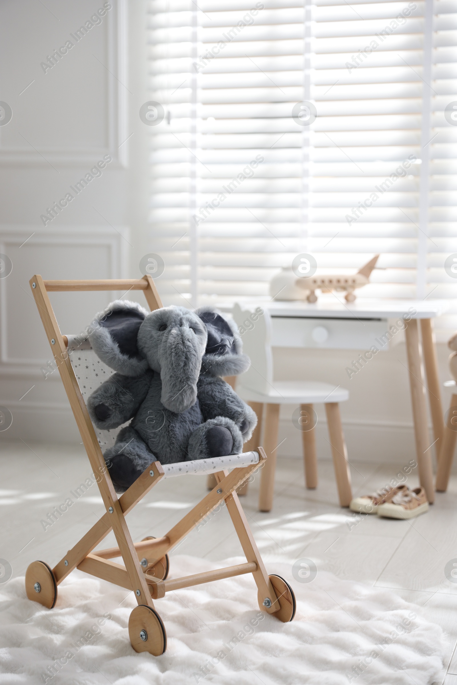 Photo of Different toys and stylish furniture in child's room