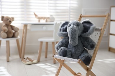 Different toys and stylish furniture in child's room