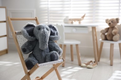 Different toys and stylish furniture in child's room