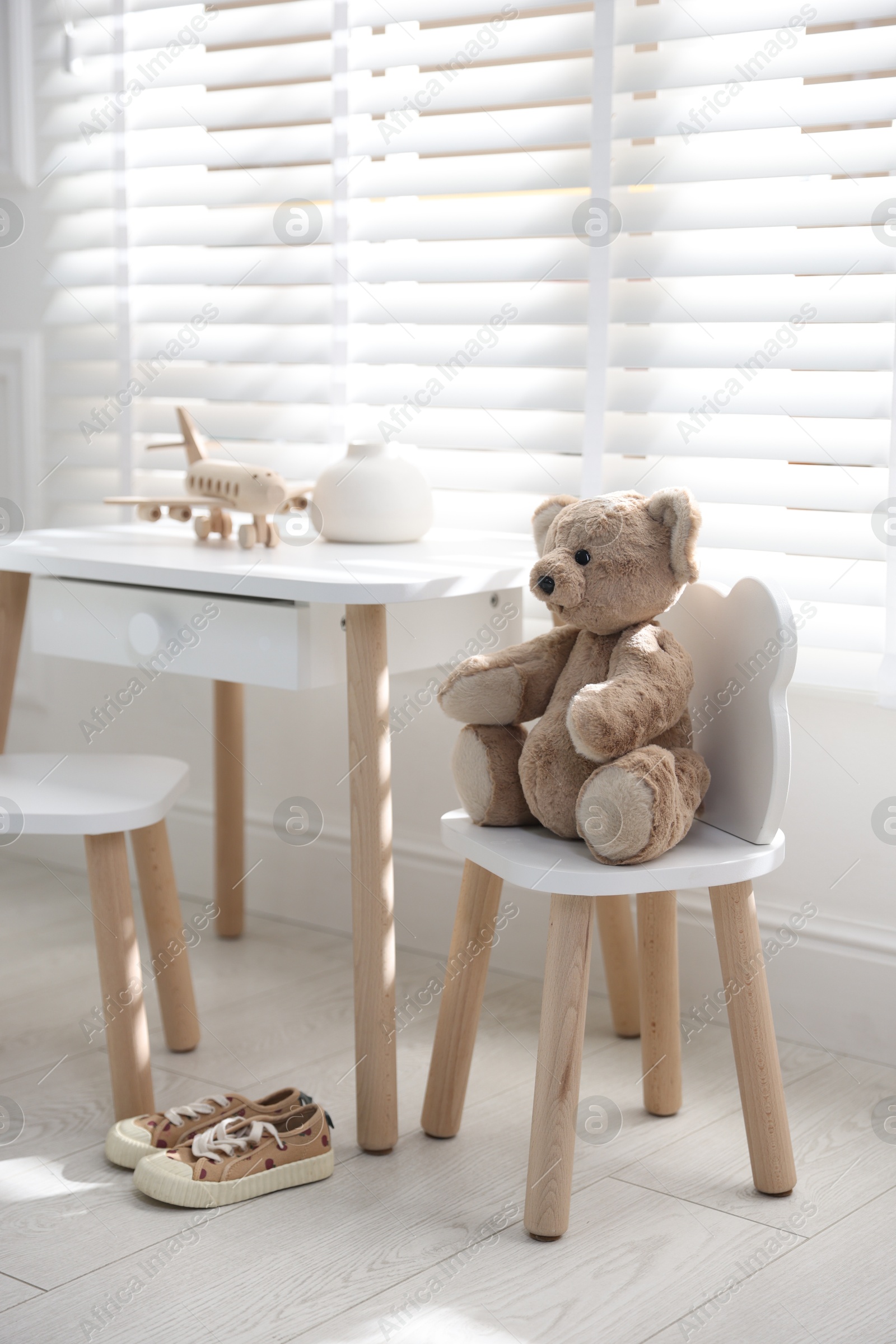 Photo of Different toys and stylish furniture in child's room