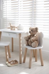 Different toys and stylish furniture in child's room