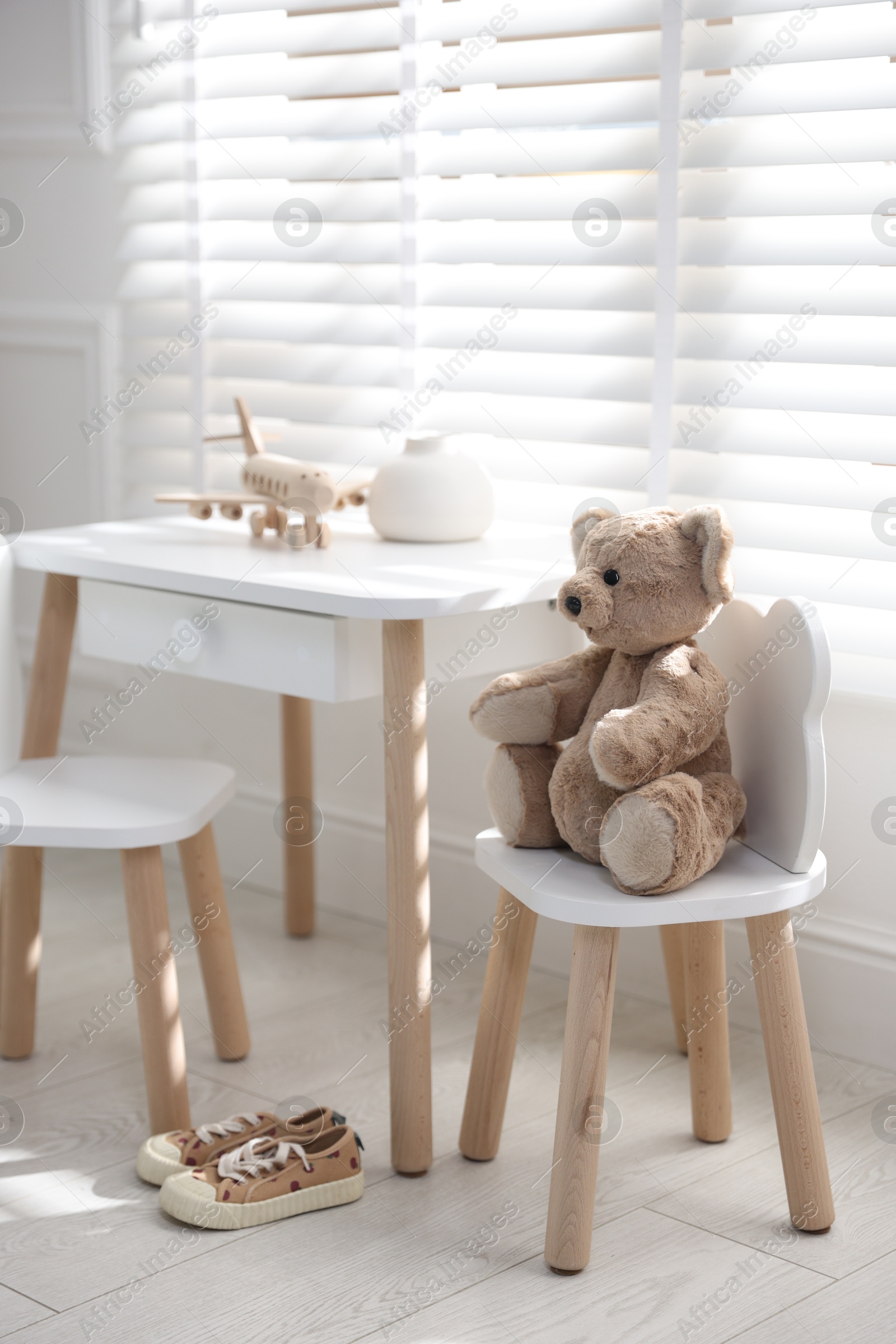 Photo of Different toys and stylish furniture in child's room