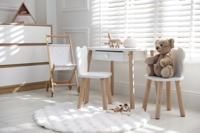 Photo of Different toys and stylish furniture in child's room