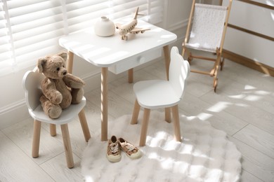 Different toys and stylish furniture in child's room