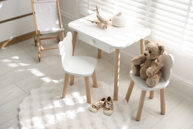 Different toys and stylish furniture in child's room