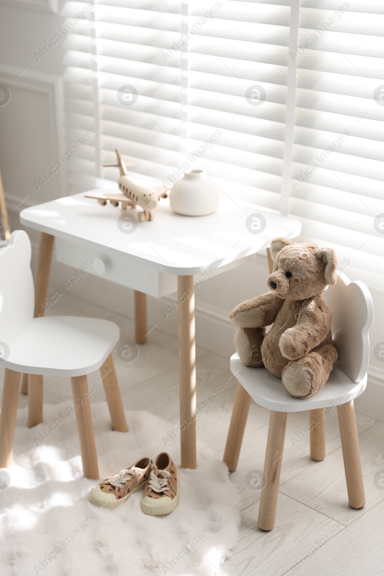 Photo of Different toys and stylish furniture in child's room