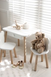 Different toys and stylish furniture in child's room