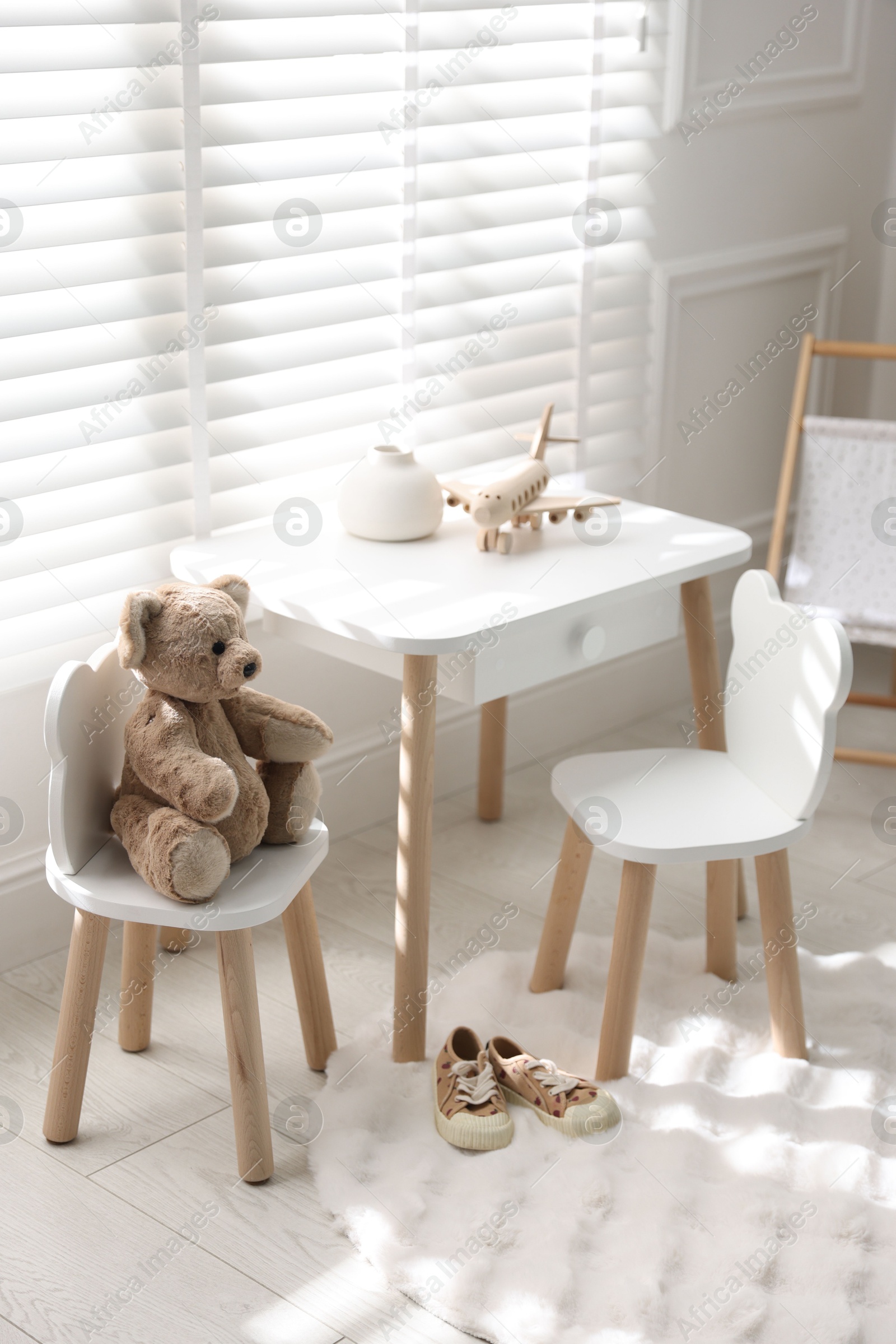 Photo of Different toys and stylish furniture in child's room