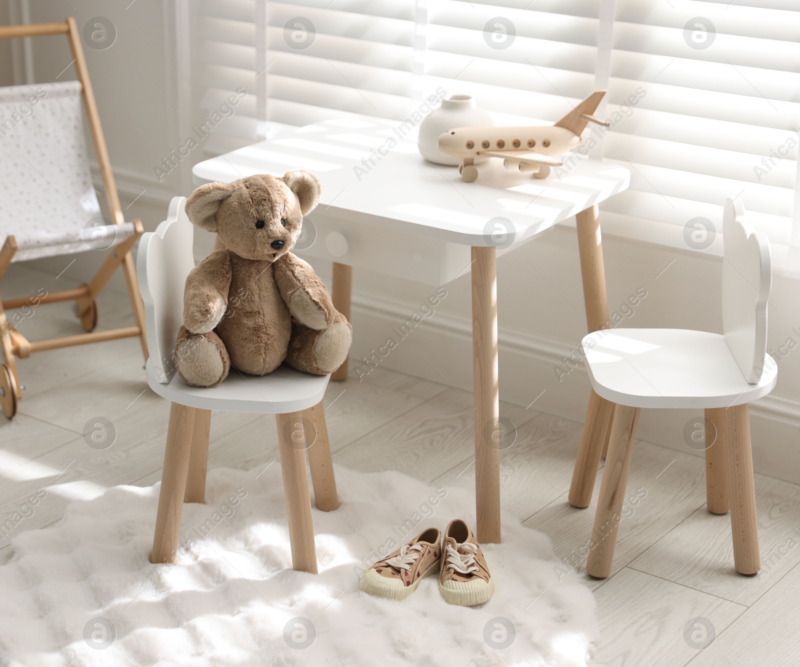 Photo of Different toys and stylish furniture in child's room