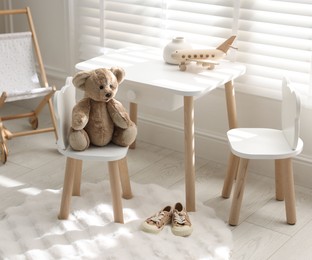 Photo of Different toys and stylish furniture in child's room