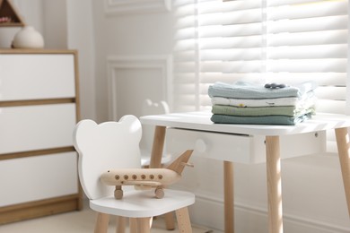 Photo of Baby swaddles and teether on table indoors